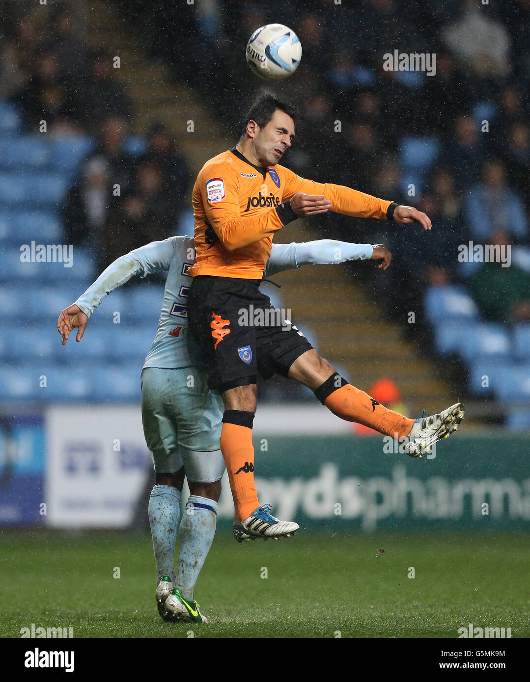 Coventry City's James Bailey and Portsmouth's Ricardo Rocha jump for the ball during the npower Football League One match at the Ricoh Arena, Coventry. Stock Photo