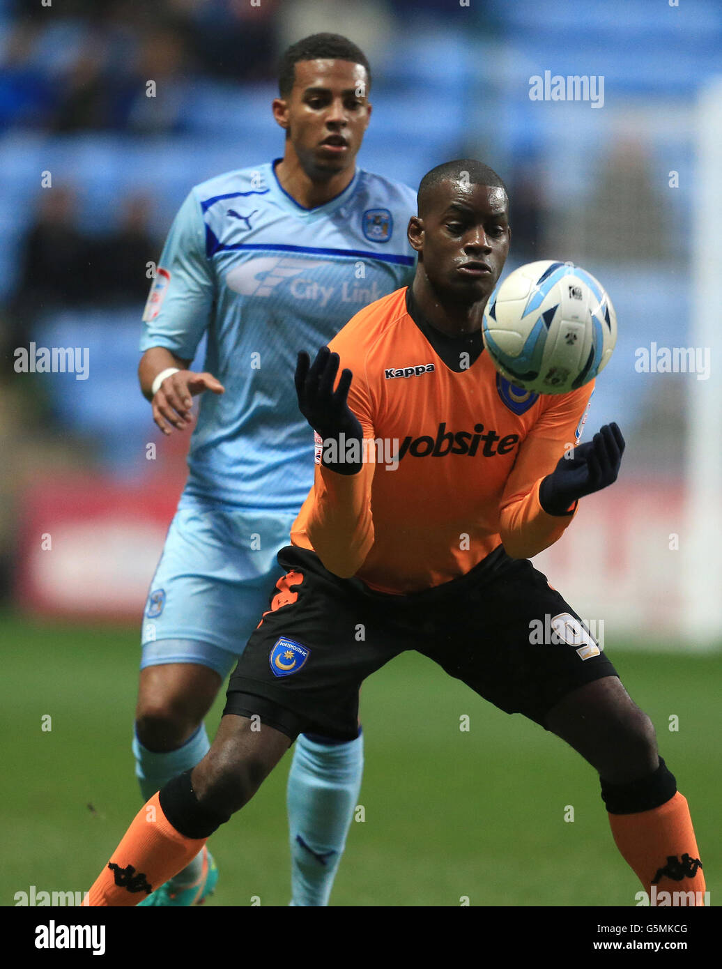 Coventry City's Cyrus Christie and Portsmouth's Izale McLeod during the npower Football League One match at the Ricoh Arena, Coventry. Stock Photo