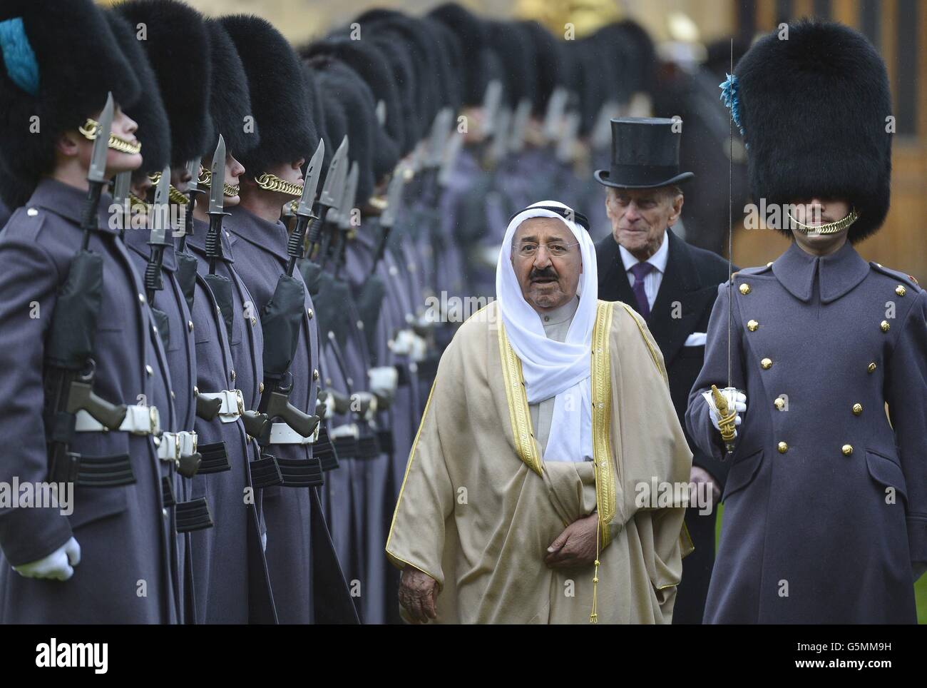 The Amir of the State of Kuwait, His Highness Sheikh Sabah Al-Ahmad Al-Jaber Al-Sabah, followed by the Duke of Edinburgh as they inspect members of the 1st Battalion Irish Guards, at Windsor Castle during the first day of his State Visit to the UK. Stock Photo