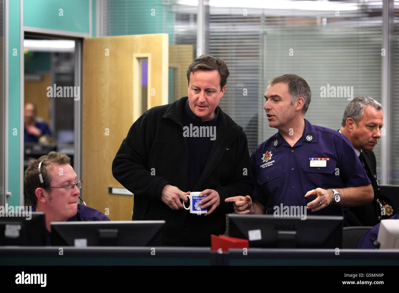 Prime Minister David Cameron meets staff at Gloucestershire Tri-Services, Gloucester. Here the Police, Ambulance and Fire & Rescue services have been working together to tackle the flooding that has hit the area. Stock Photo