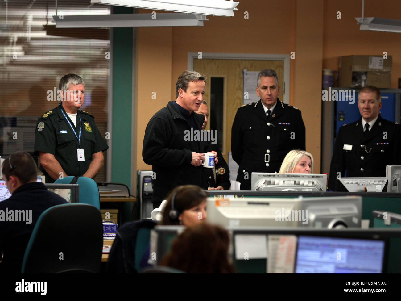 Prime Minister David Cameron meets staff at Gloucestershire Tri-Services, Gloucester. Here the Police, Ambulance and Fire &amp; Rescue services have been working together to tackle the flooding that has hit the area. Stock Photo