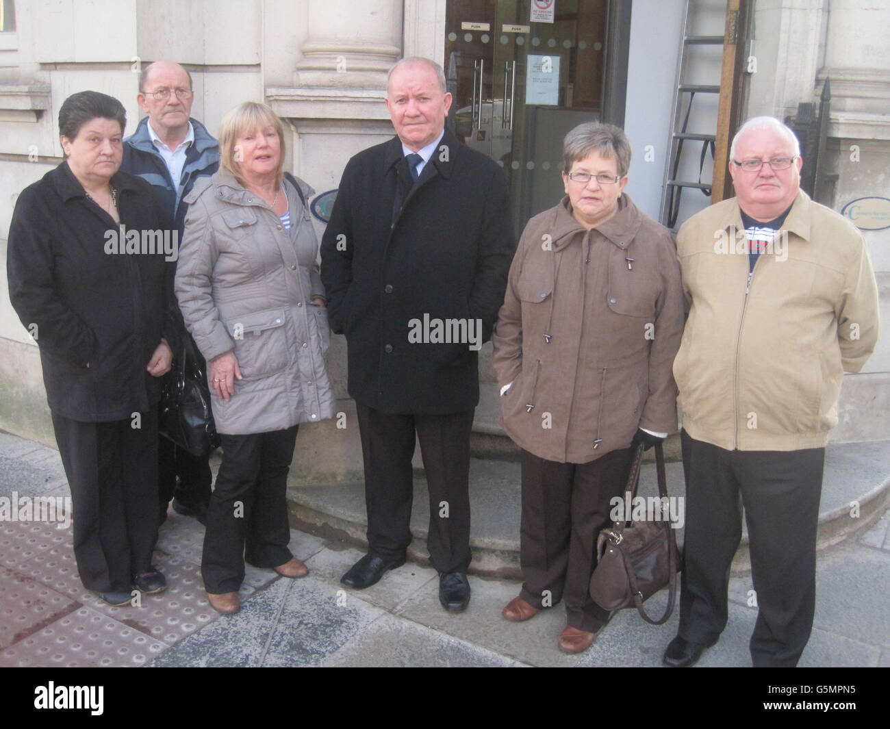David Heasley with other family memeber (names not given) outside Mays chambers coroner's court in Belfast this morning, as a coroner has told the family of a pensioner who died after an assault that he is powerless to address their concerns about the prosecution of his killer. Stock Photo