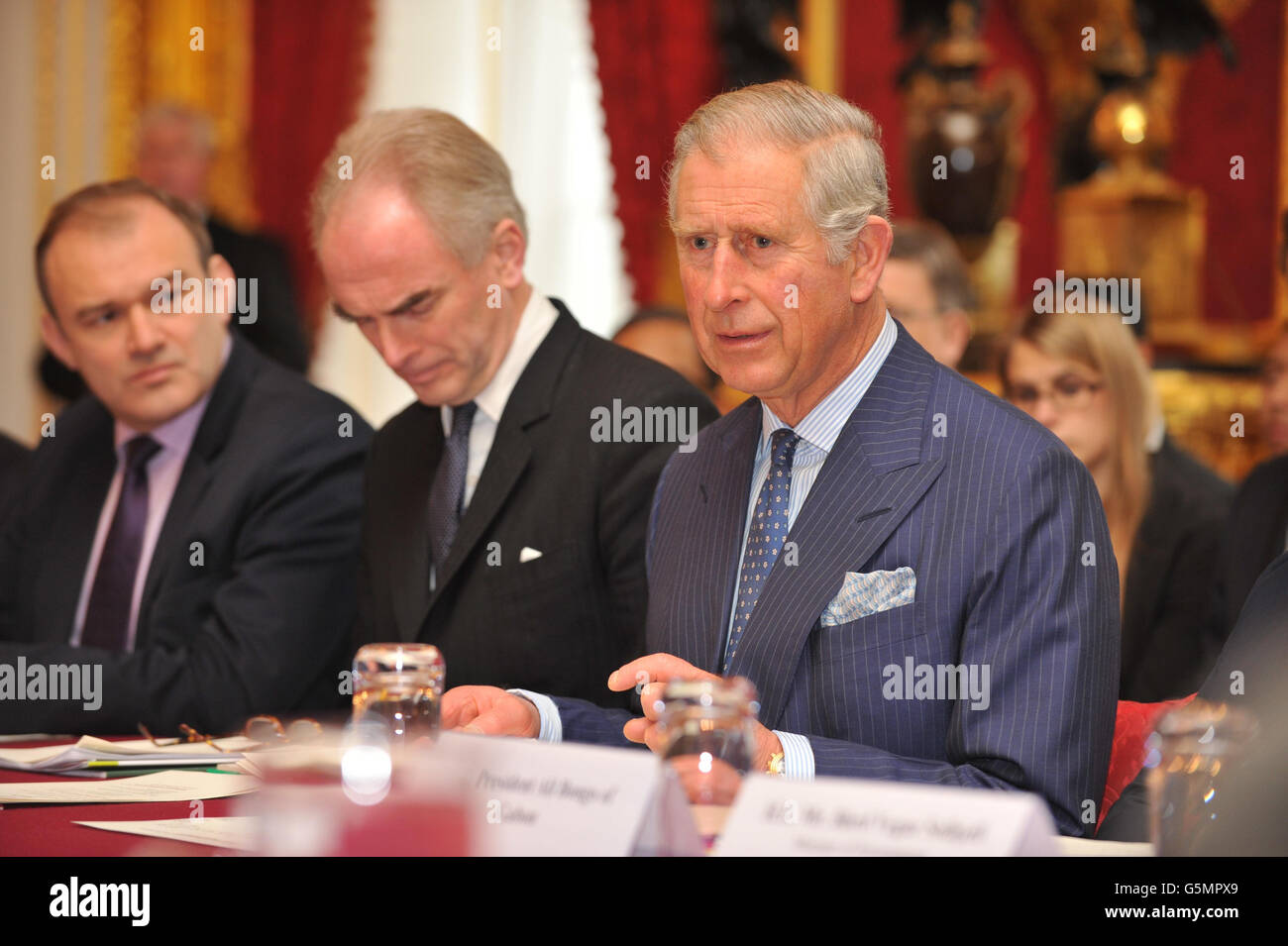 (left to right) Secretary of State for Engery and Climate Change, Ed Davey, Justin Mundy, Head of Prince's International Sustainability Unit (ISU), listen as the Prince of Wales, talks during a meeting of international leaders to discuss curbing world deforestation, in the Thorne Room at Clarence House, London. Stock Photo