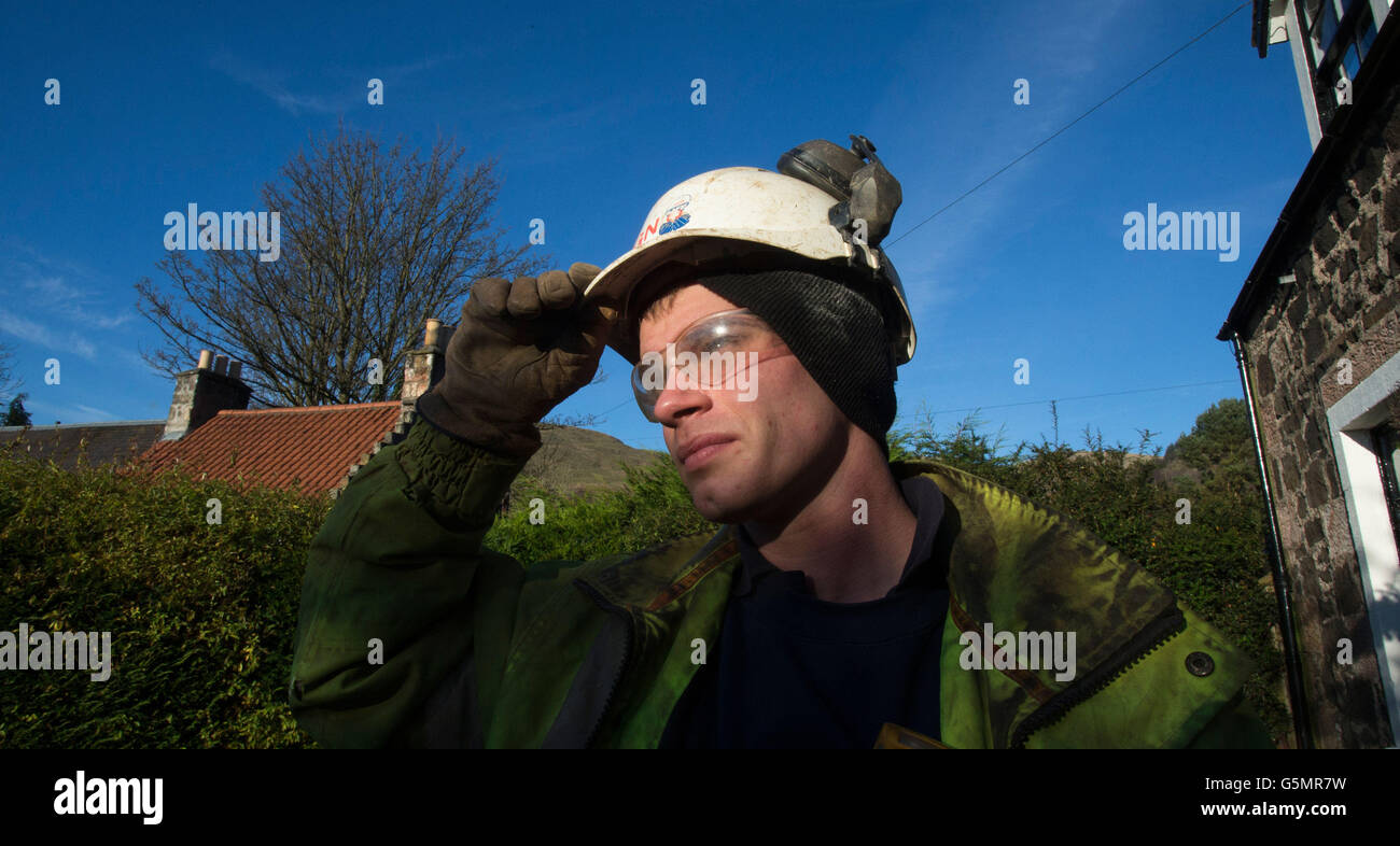 A Scotland Gas Networks employee works to restore gas to a house in Dollar as 2,500 homes remain without central heating or hot water for a third day. Stock Photo