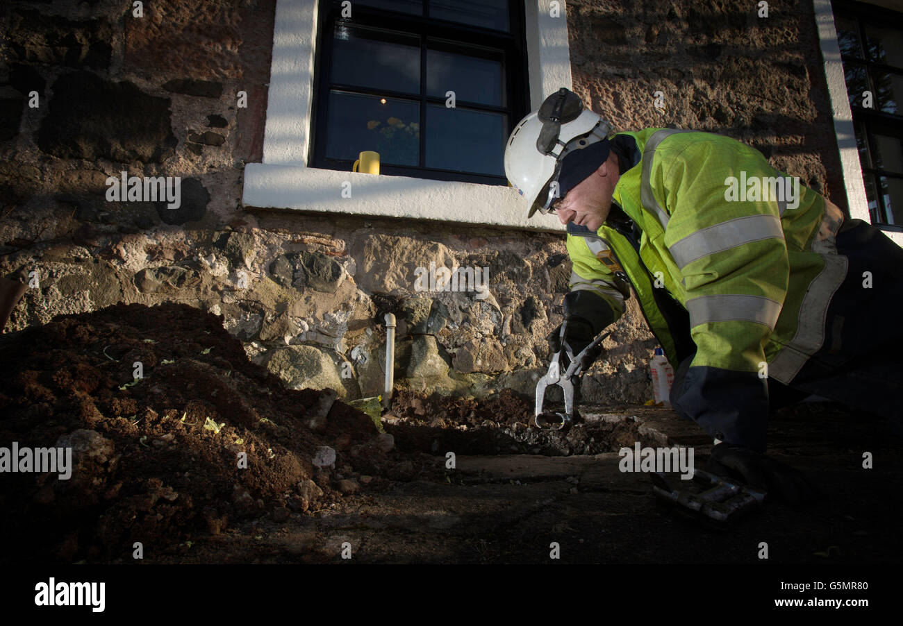 A Scotland Gas Networks employee works to restore gas to a house in Dollar as 2,500 homes remain without central heating or hot water for a third day. Stock Photo