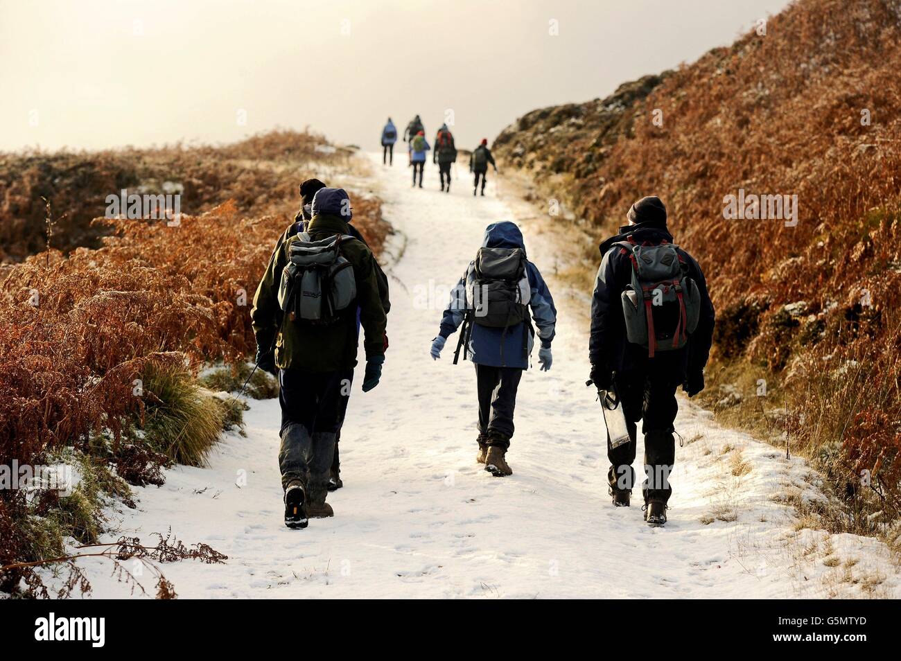 Walkers on the snow covered bridleway on Carlton Bank in the Cleveland Hills, North Yorkshire, after Snow fell across parts of the country, with more predicted over the weekend. Stock Photo