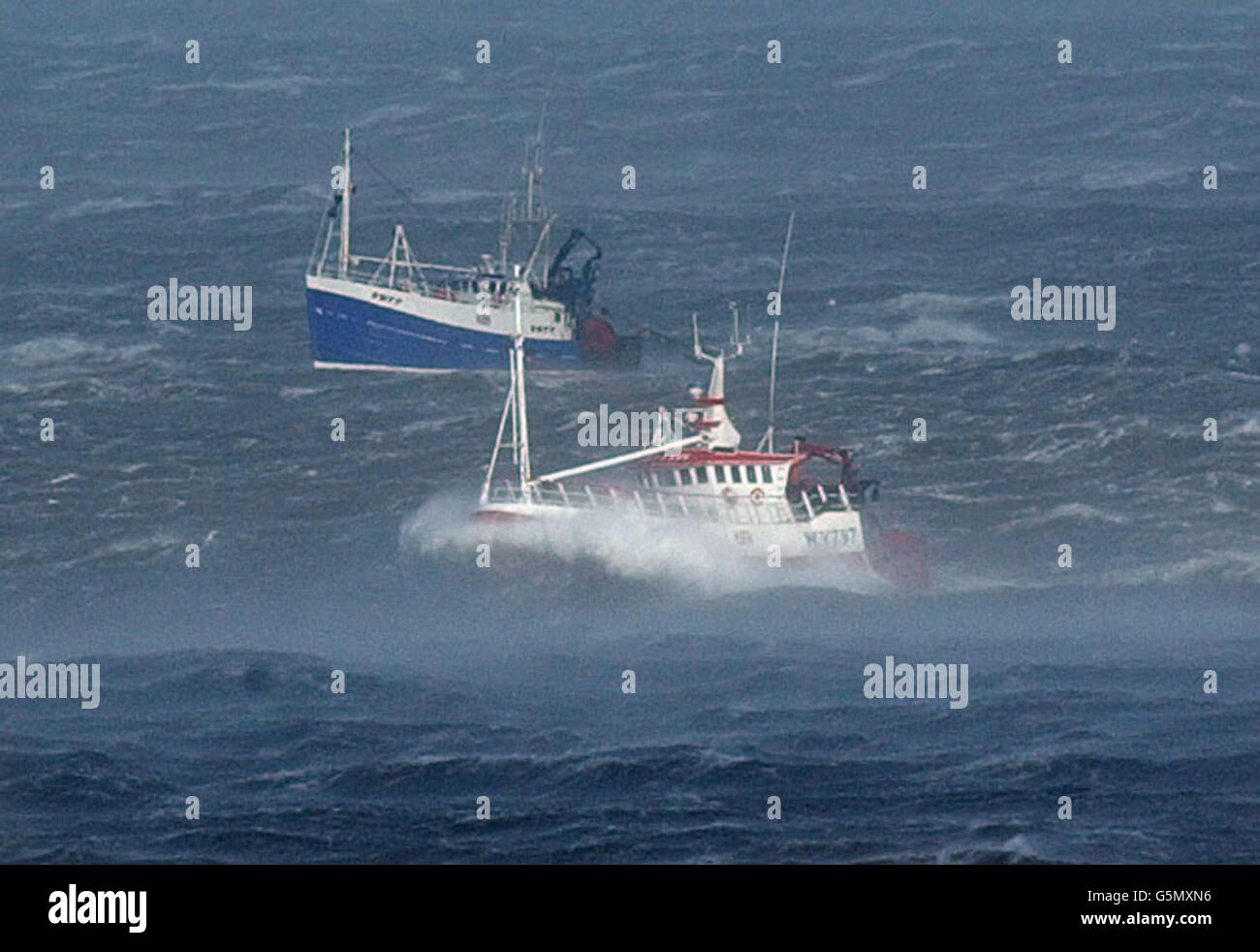 Heading for safe harbour, fishing boats plough through gale force winds for the safety of the port of Whitby on the Yorkshire coast, as severe storms battered Britain. * Elsewhere, around 10,000 customers lost their electricity after gusts up to 90mph damaged power lines in Scotland. 16/08/02 : Those who go down to sea in ships have the most dangerous jobs in the country, it was revealed. A study found that even in 2002 merchant seamen and trawler fishermen were still far more likely to die in accidents than other workers. Fishermen were 50 times more likely to have a fatal work accident and Stock Photo