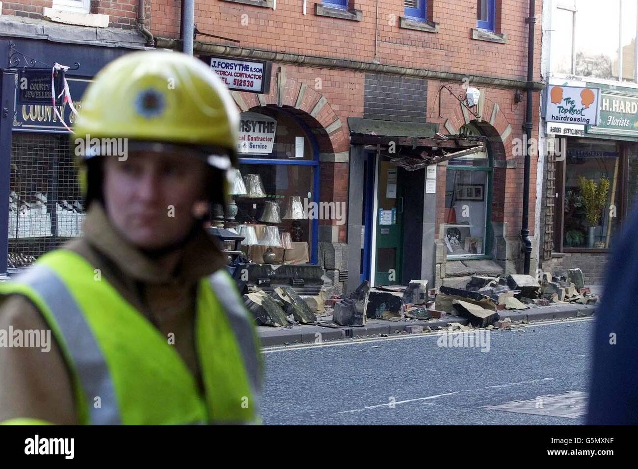 A fireman views the damage caused by high winds in Morpeth High Street, Morpeth, Northumberland. One person was injured when the roof was blown off, sending rubble crashing down onto the street below. * Thousands of homes were without electricity as severe gales up to 100mph continued to batter parts of Britain. The misery of the heavy rain and strong winds, which have been the worst seen in recent years, was expected to ease later. Stock Photo