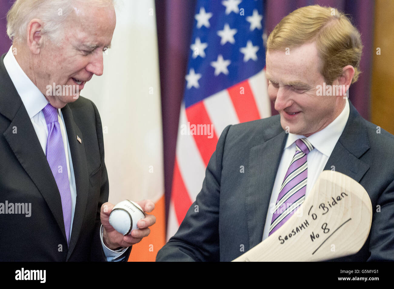 Taoiseach Enda Kenny (right) welcomes United States Vice-President Joe Biden to Government Buildings, Dublin, Ireland at the start of his six day visit and gives him a gift of a hurling stick and sliothar, and the hurling stick has the vie-president's name written in Gaelic on it. Stock Photo