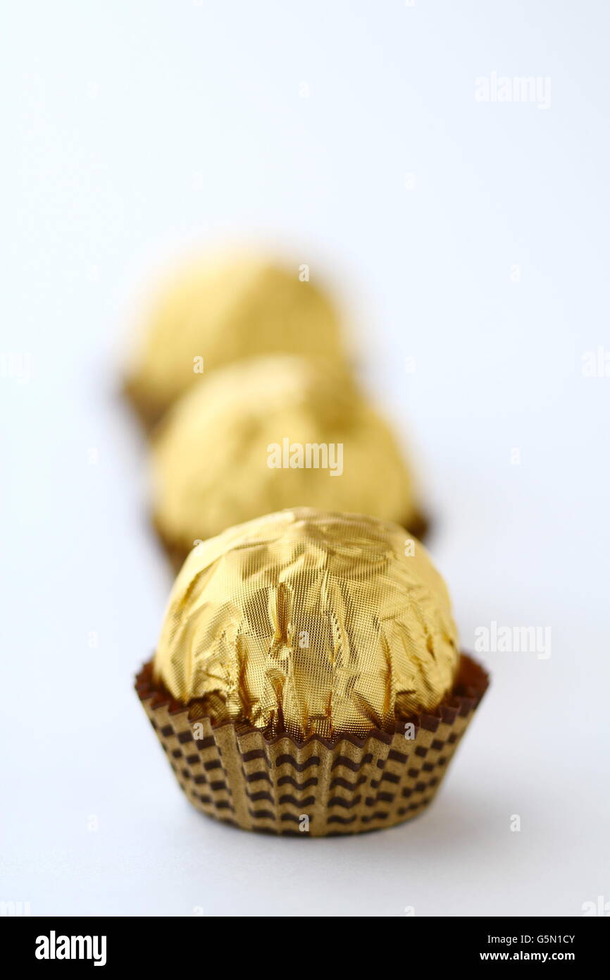 Close up of Chocolates individually wrapped in gold metallic wrapper