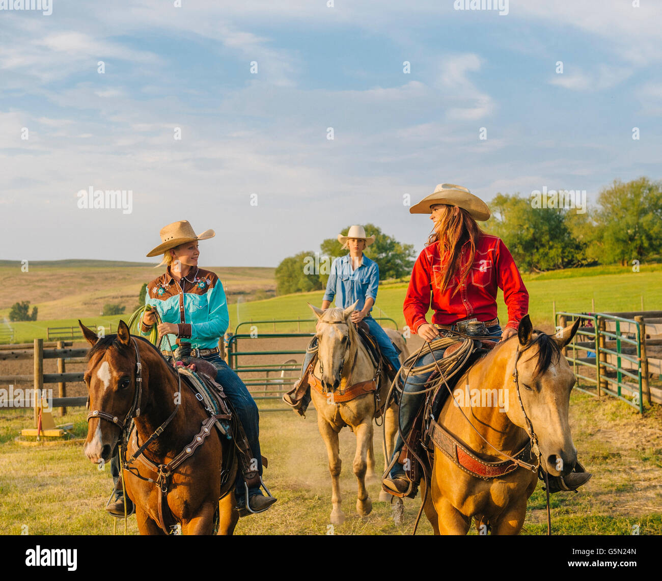 Cowgirls riding horseback on ranch Stock Photo