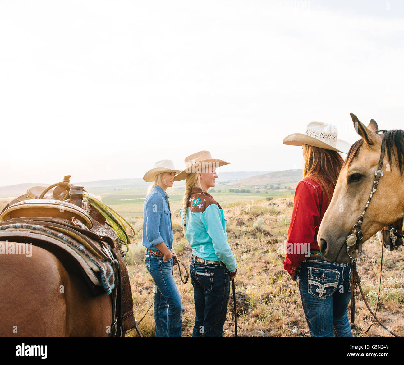 Cowgirls with horses on ranch Stock Photo