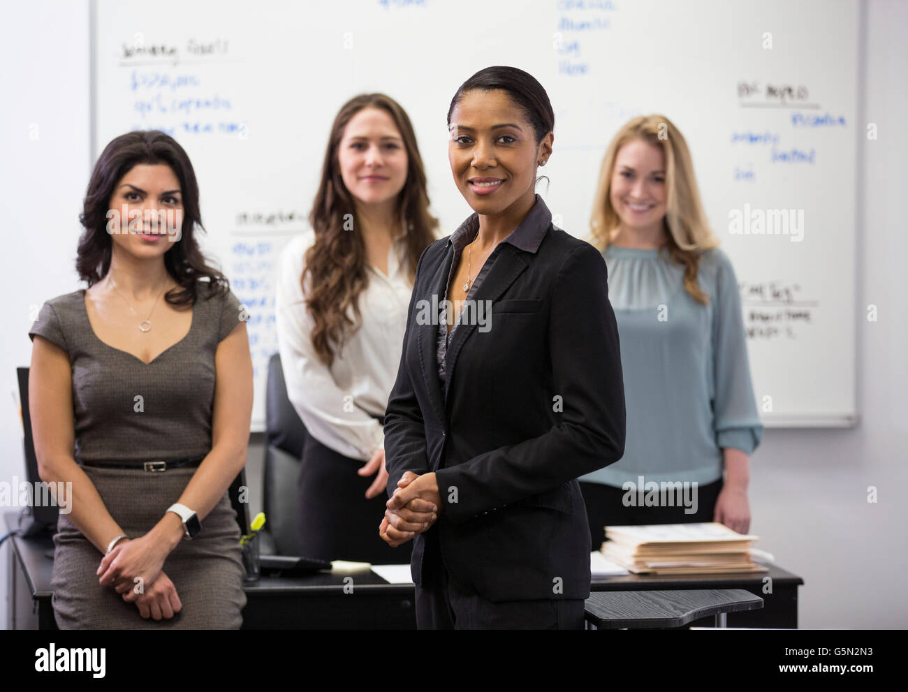 Businesswomen smiling in office Stock Photo