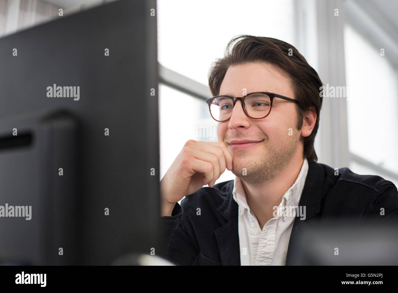 Caucasian businessman using computer in office Stock Photo