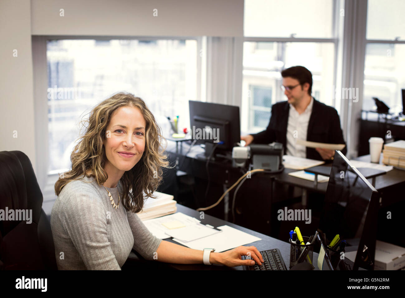 Caucasian businesswoman smiling in office Stock Photo