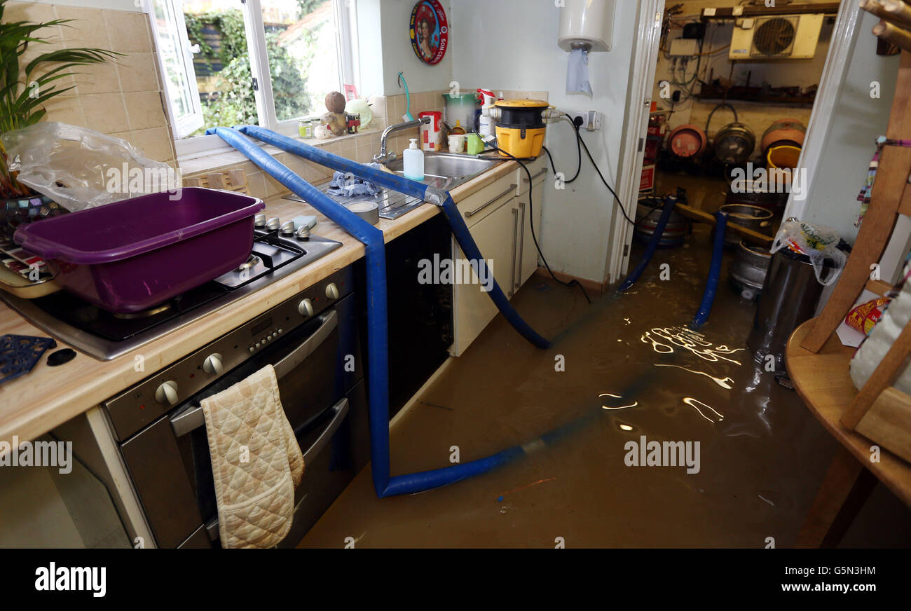 Flood water is pumped out of the kitchen and cellar of the White Bear Pub in Tewkesbury. Stock Photo