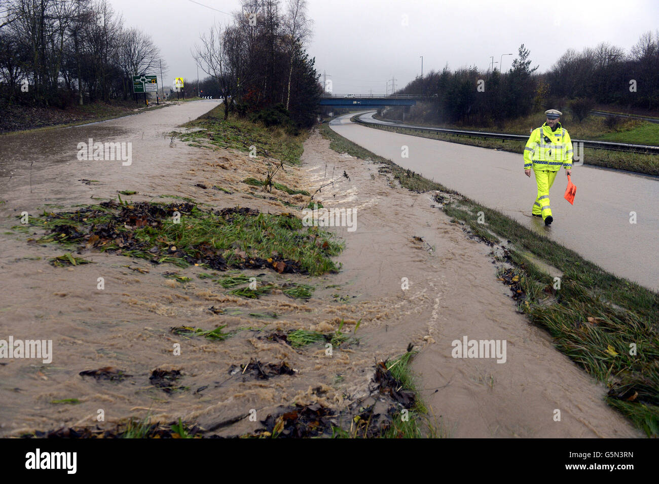 A police walks through flood water on the A19 near Sunderland which ...