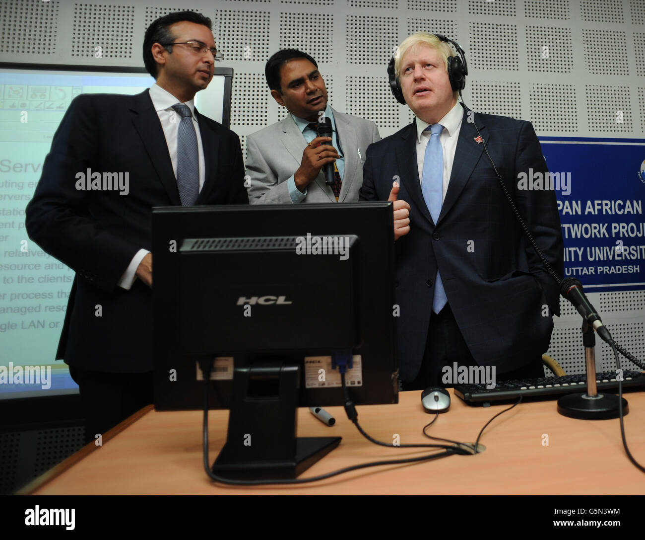 London Mayor Boris Johnson (right) holds a video conference call with students and pupils from four African schools during a visit to Amity University in Uttar Pradesh near Delhi, where he addressed members of the university and took questions from Indian students, as part of a week long tour of India to persuade Indian businesses to invest in London. Stock Photo