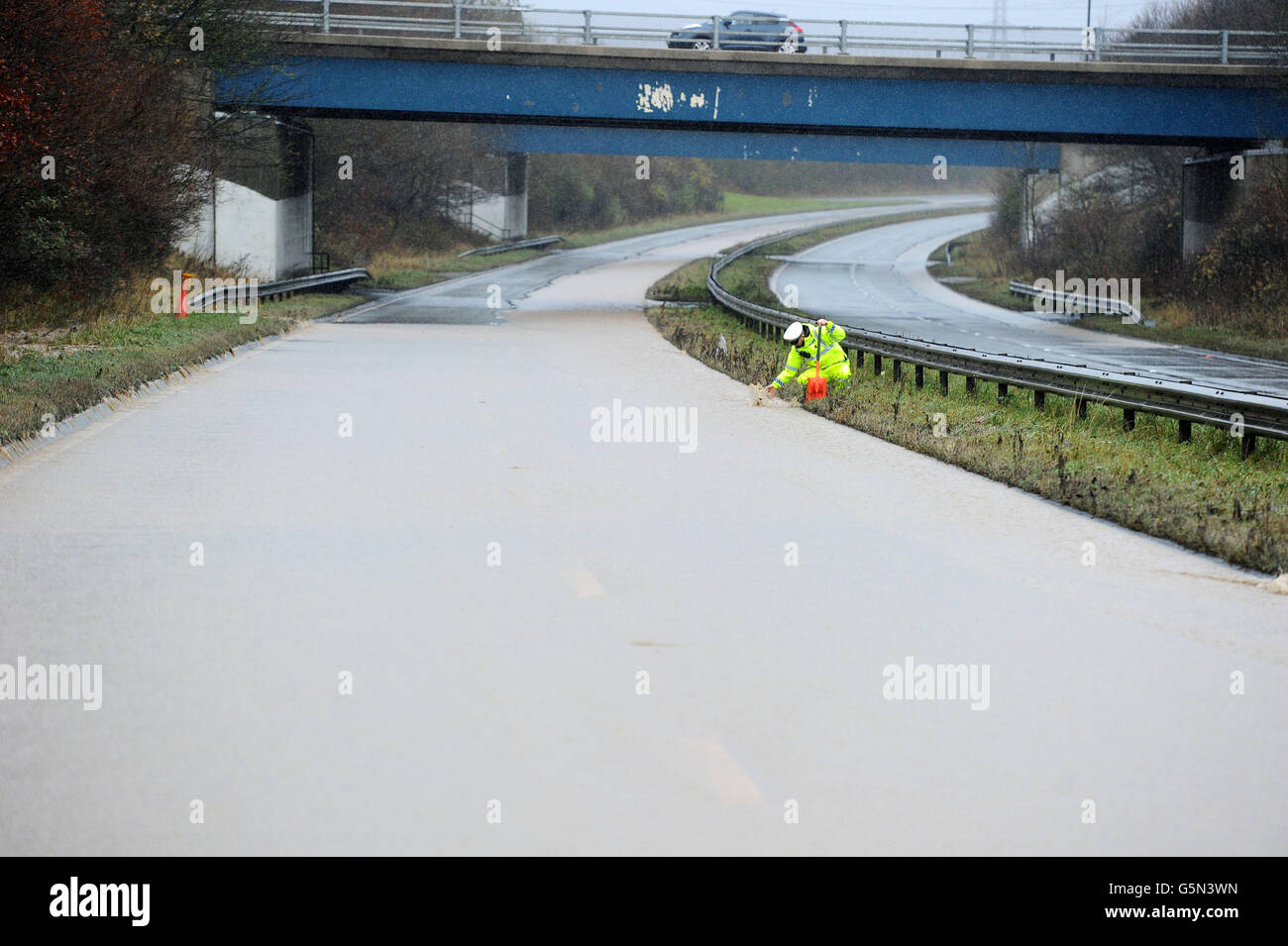 A police officer checks drains on the A19 near Sunderland which remains ...