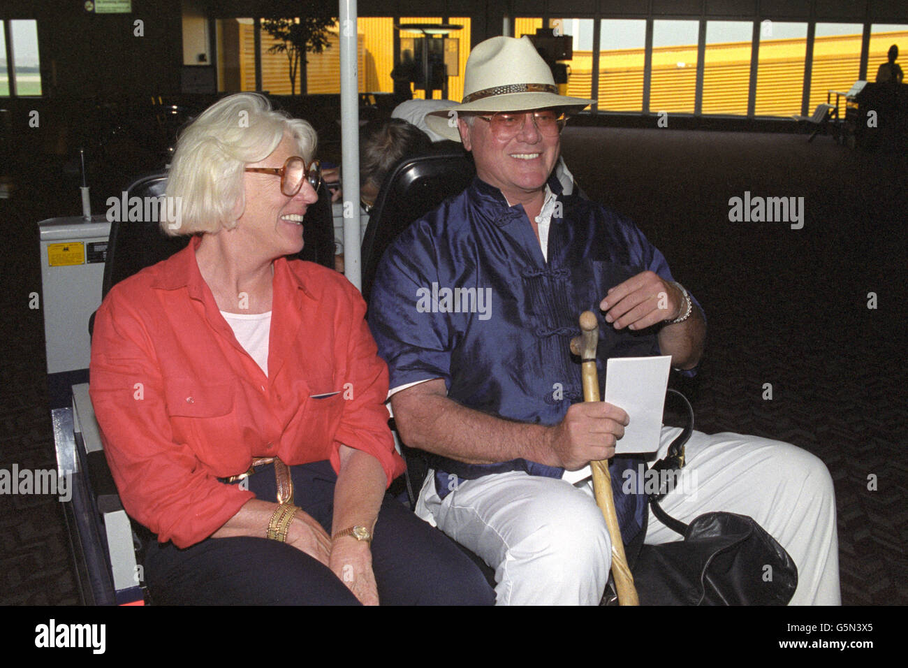 Actor Larry Hagman and his wife Maj at Heathrow Airport in London before departing for Los Angeles in America. Stock Photo