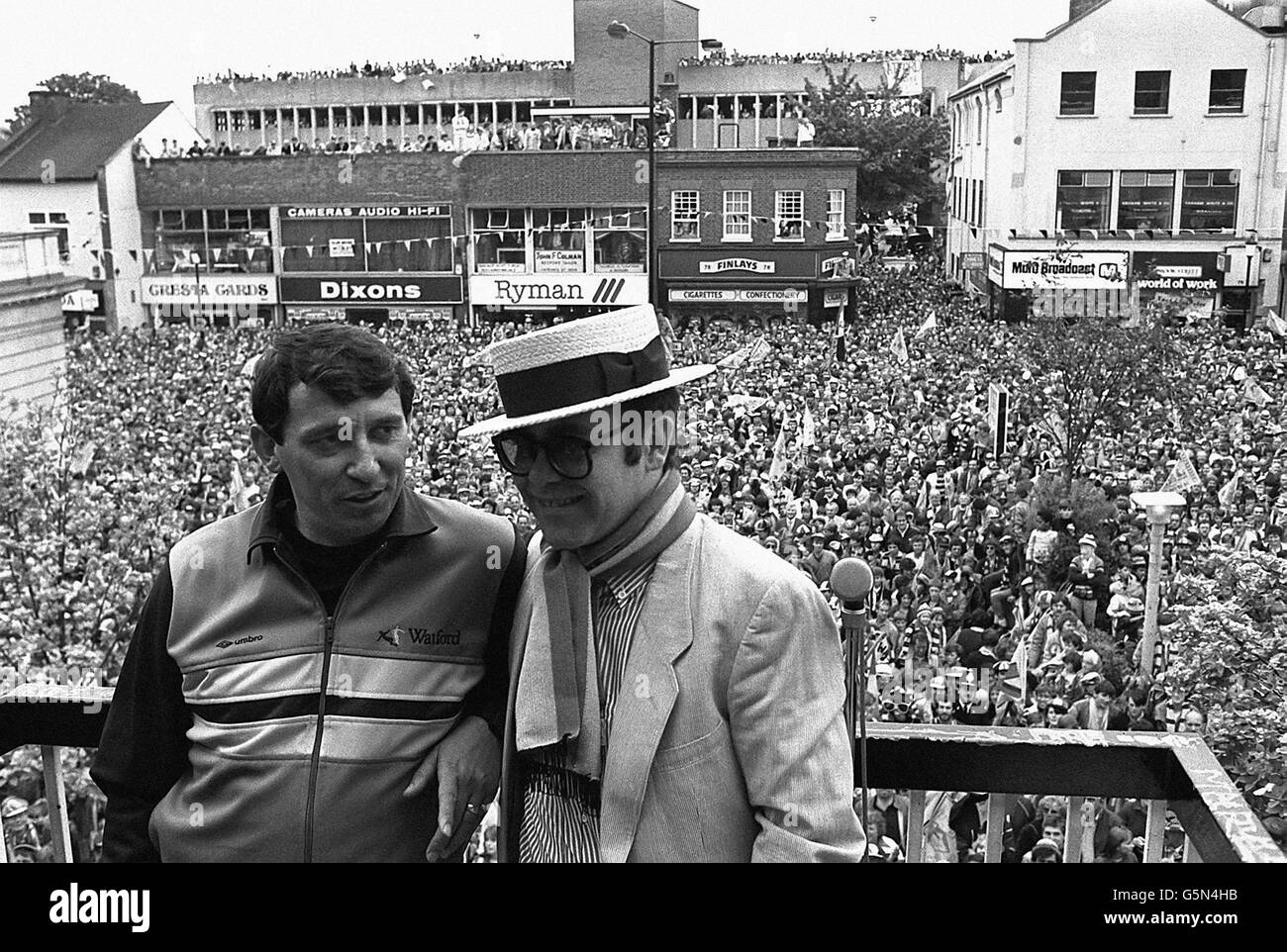 Watford Football Club Chairman Elton John wearing the club scarf with team manager Graham Taylor on a balcony overlooking a crowd of well wishers. It was the clubs first appearance in their 93 year history. Stock Photo
