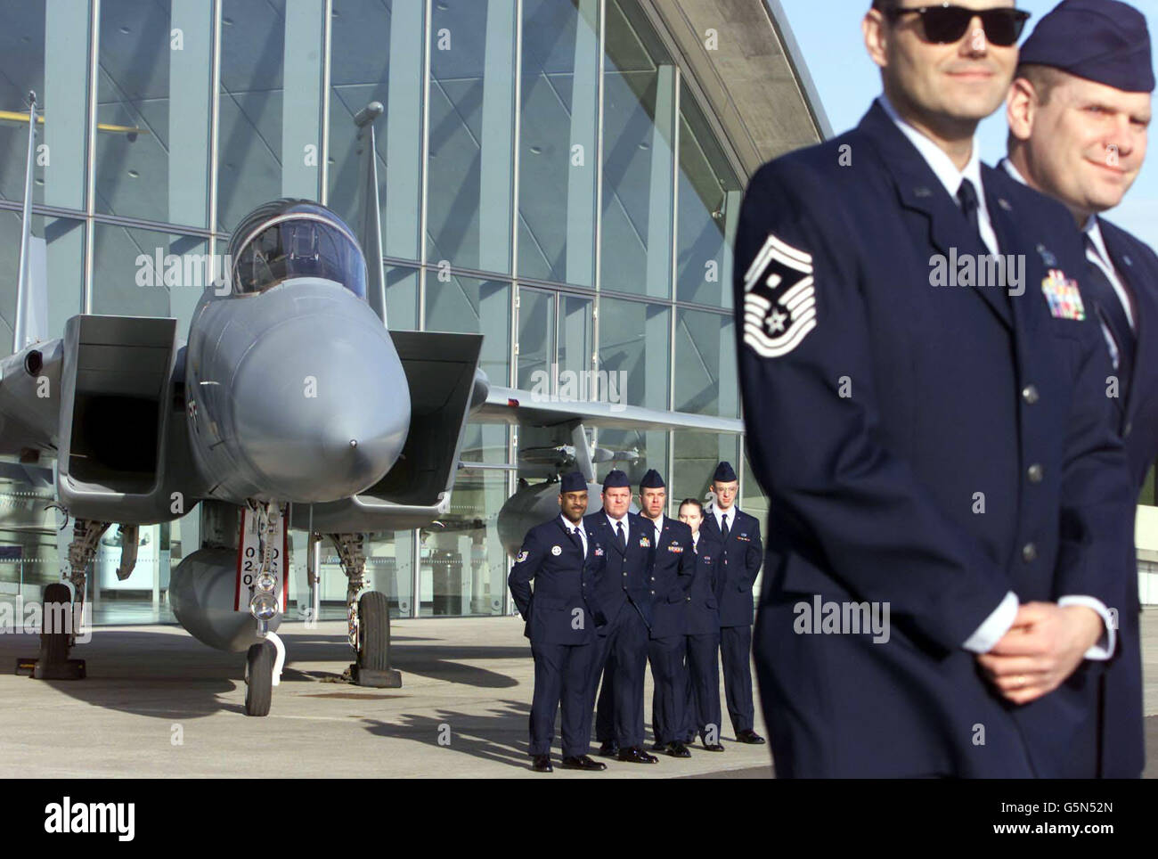 Members of the USAF 48th Fighter Wing from RAF Lakenheath in Suffolk, stand in front of the F15a Eagle jet fighter which they volunteered to restore, at the Duxford Air Museum, Cambridgeshire. The extraordinary 30.1 million exhibit was donated to the museum, * by the USAF but required restoration before it could go on display. The F-15 provided the backbone of the United States Air Force's fighting capabilities in the 1990's. Stock Photo