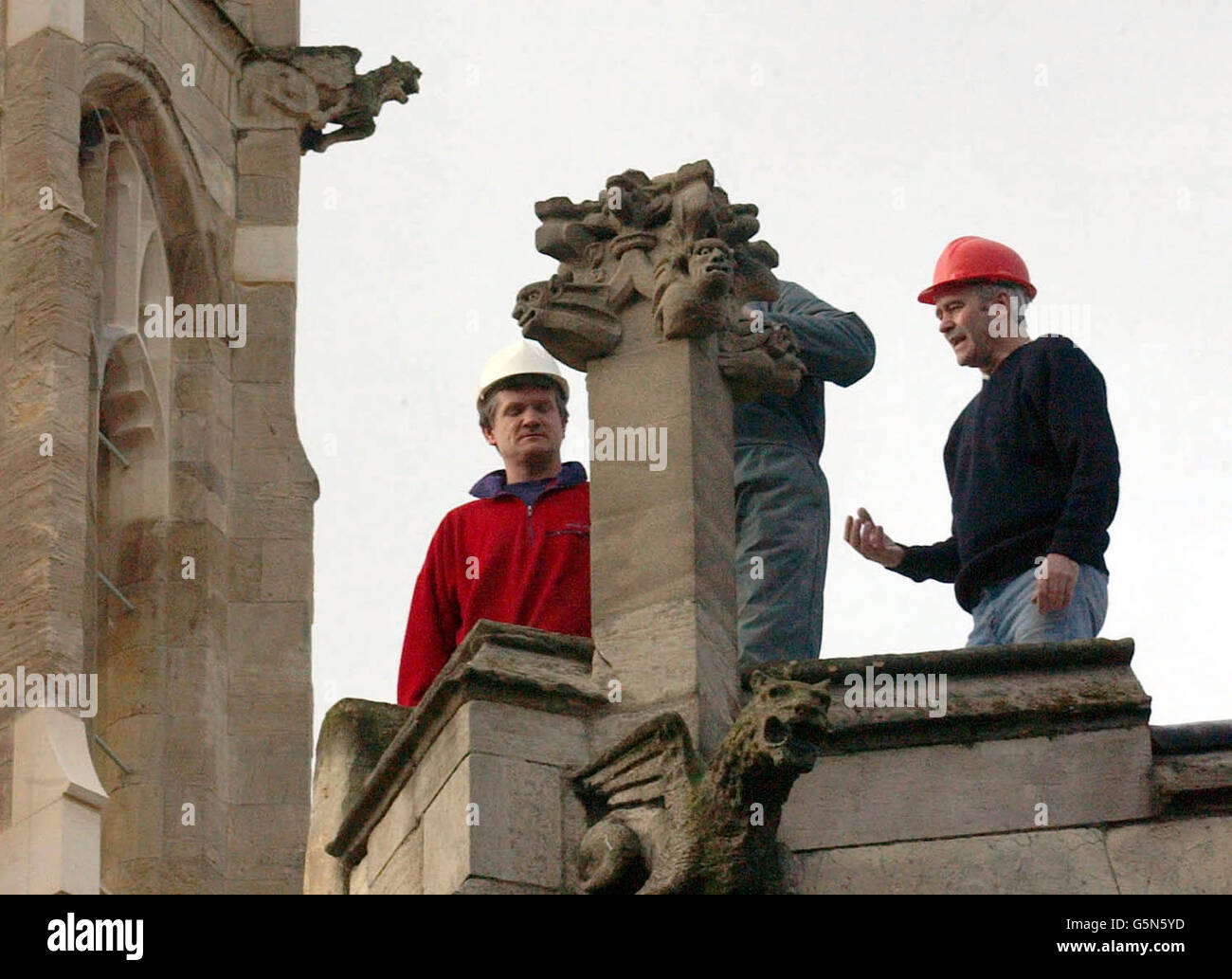Workmen inspect the base of a column at All Saints Church in York, after a piece of masonry fell from the roof during gale force winds in the city last night, killing a woman who was walking undernearth. Stock Photo
