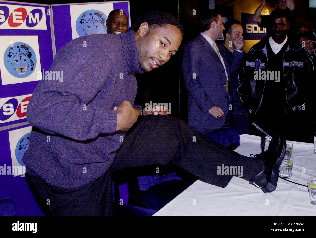Britain's World Heavyweight Boxing Champion, Lennox Lewis shows the press the leg that he claims was bitten by Mike Tyson, at a press conference in central London. * The conference was called after the hearing in Nevada USA, which stopped the planned Lewis v Mike Tyson title fight from going ahead in Las Vegas. Lewis admitted he was considering suing Mike Tyson after revealing the controversial American bit out 'a significant piece of flesh during their press conference brawl in New York.' Stock Photo