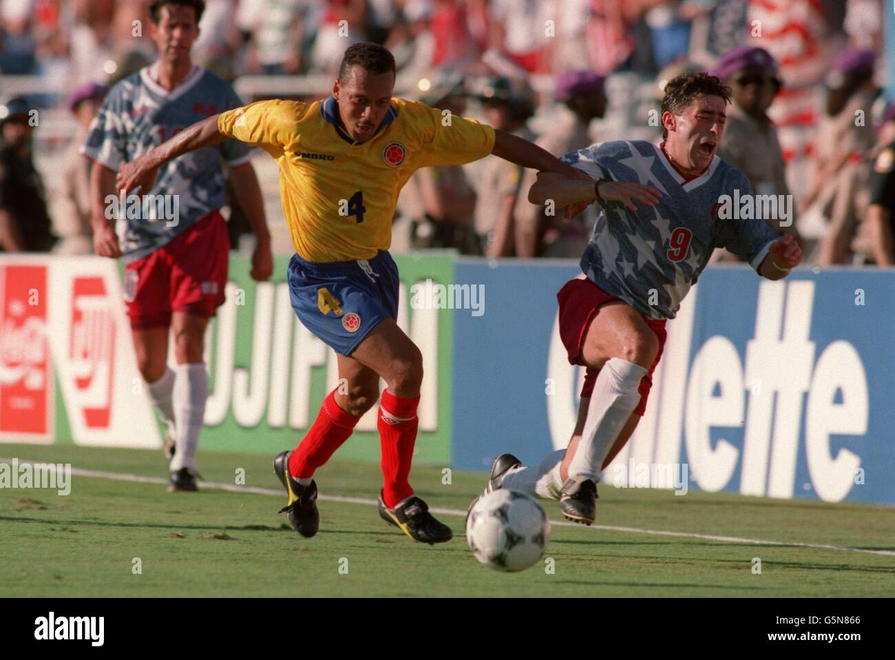 Soccer - World Cup USA 94 - Group A - USA v Colombia. USA's Tab Ramos is pushed off the ball by Colombia's Luis Enrique Herrea Stock Photo