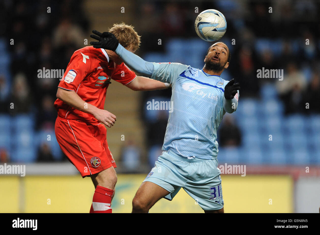 Coventry City's David McGoldrick and Walsall's Dean Holden battle for the ball during the npower Football League One match at the Ricoh Arena, Coventry. Stock Photo