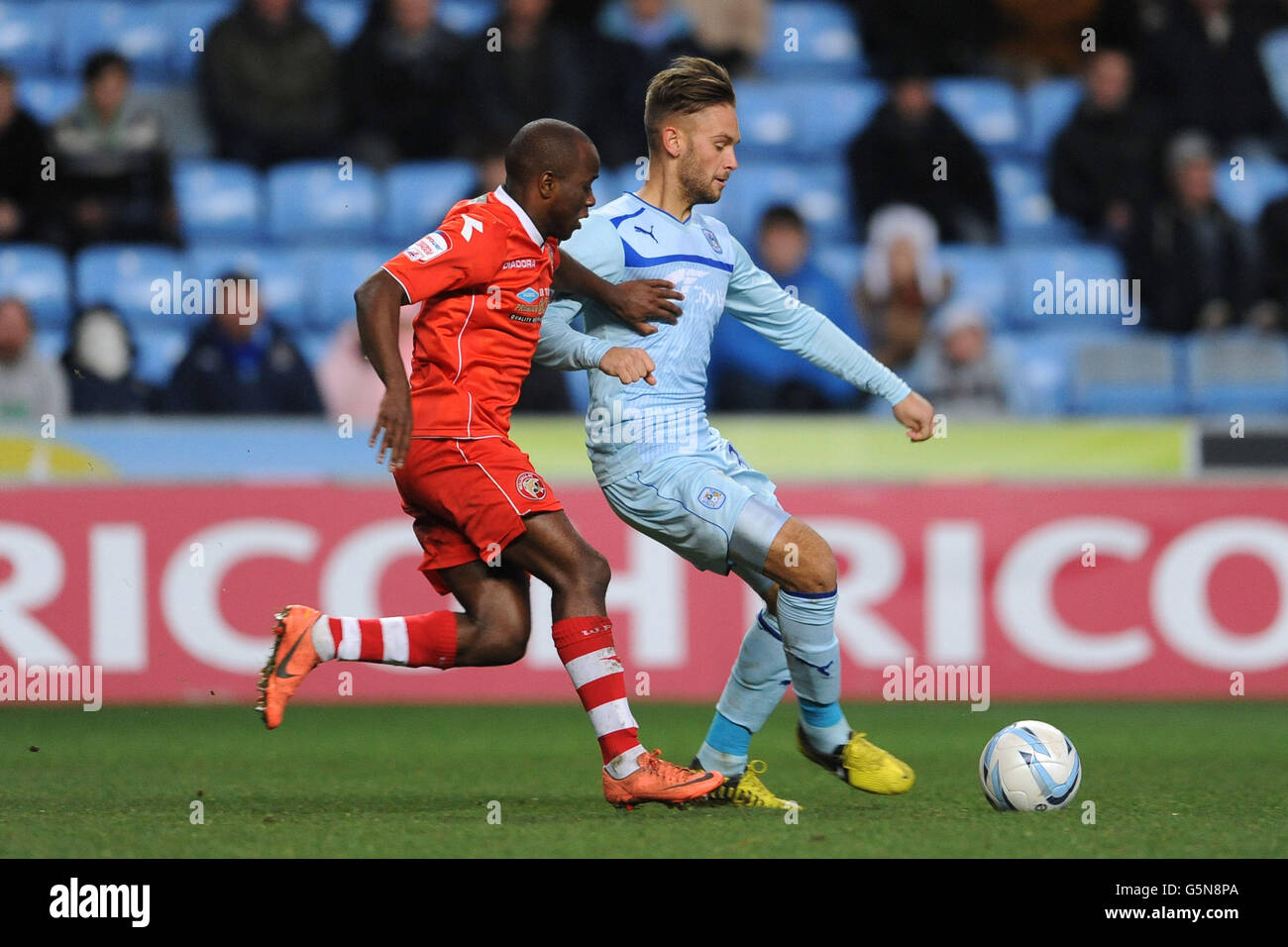 Coventry City's James Bailey and Walsall's Fabian Brandy battle for the ball during the npower Football League One match at the Ricoh Arena, Coventry. Stock Photo