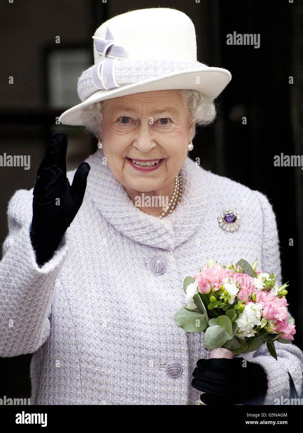 Queen Elizabeth II waves during her visit to the Bank of England in central London. Stock Photo