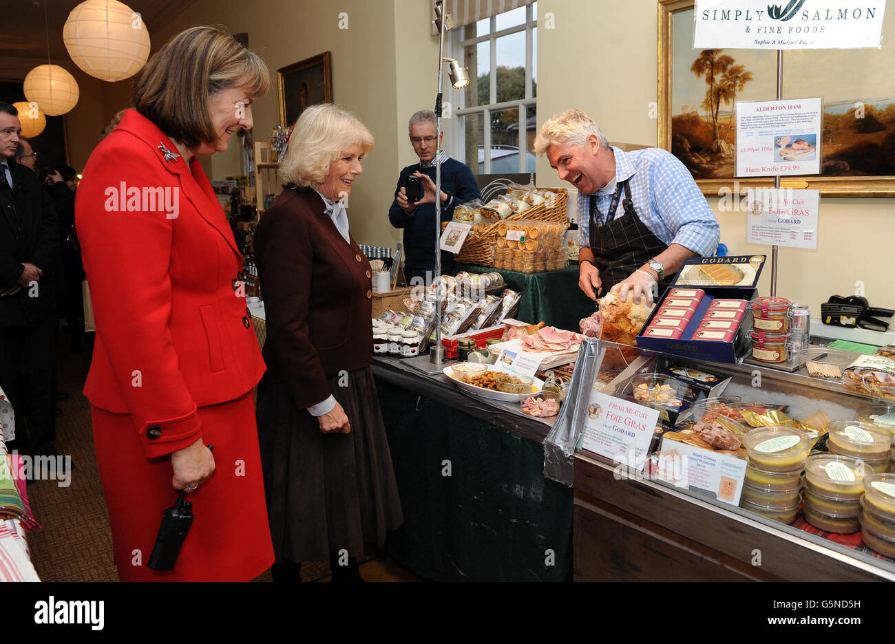 The Duchess of Cornwall with lady Lansdowne looks at stalls during a