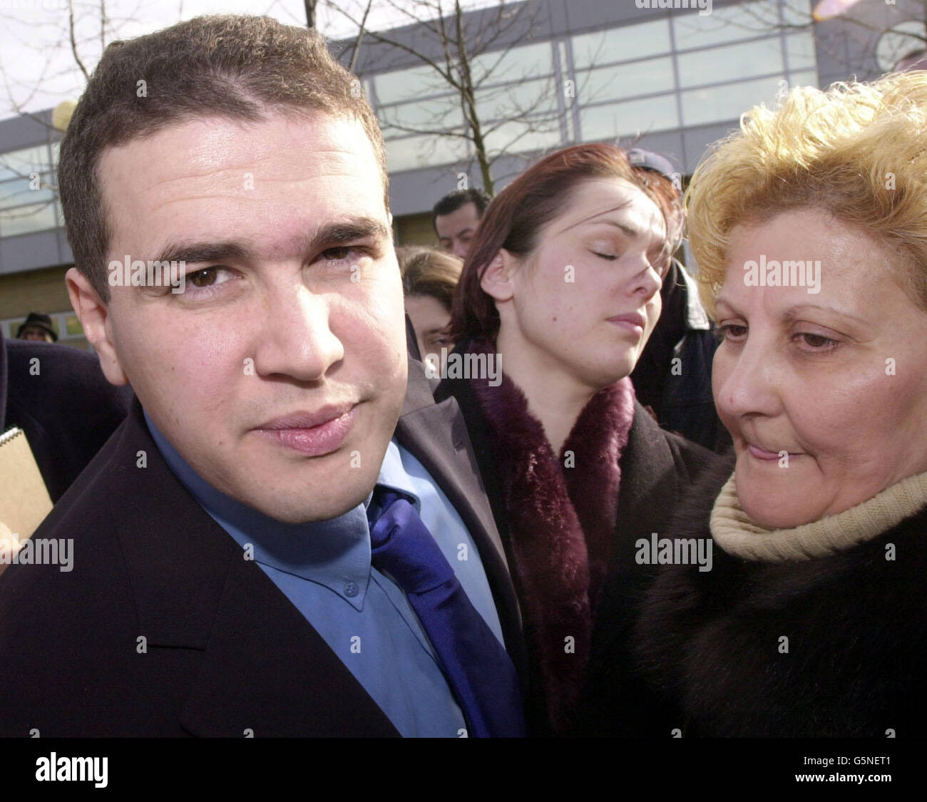 Algerian pilot Lotfi Raissi, 27, who has been accused of training the suicide hijackers who crashed into the Pentagon on September 11, walks free from Belmarsh Magistrates Court in south-east London with his wife Sonya (centre) and mother Rabea. * after he was granted bail Tuesday February 12, 2002 at an extradition hearing. District Judge Timothy Workman said Raissi, who lives near Heathrow airport, said that he could have conditional bail as he was only facing extradition to the US on two counts of falsifying an application for a US pilot's licence. Stock Photo