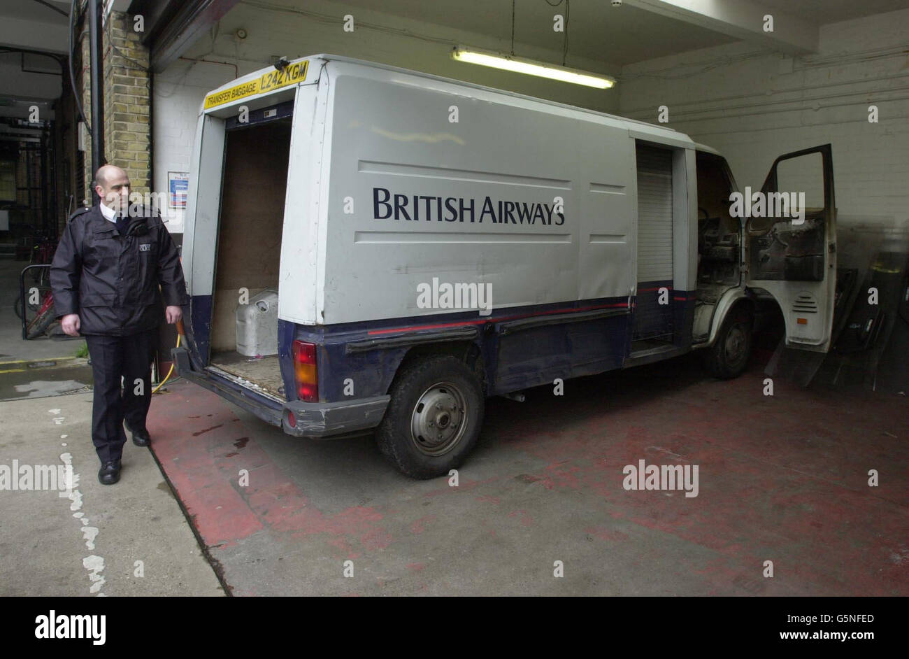 A police officer inspects the van used by robbers who attacked a BA security van in a secure airside cargo loading area near Heathrow Airport's Terminal 4, and who escaped with 4.6 million. * The vehicle was subsequently found abandoned and burning two miles away in a residential area in Feltham, west London. Government ministers responsible for aviation security have ordered a report on how thieves managed to gain access to the airport's restricted zone during a period of heightened security in the wake of events on September 11. Stock Photo