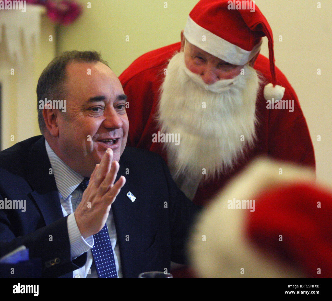 Scottish First Minister Alex Salmond talks to Santa Arthur Martin as they visit the Lifecare care centre Edinburgh. Stock Photo