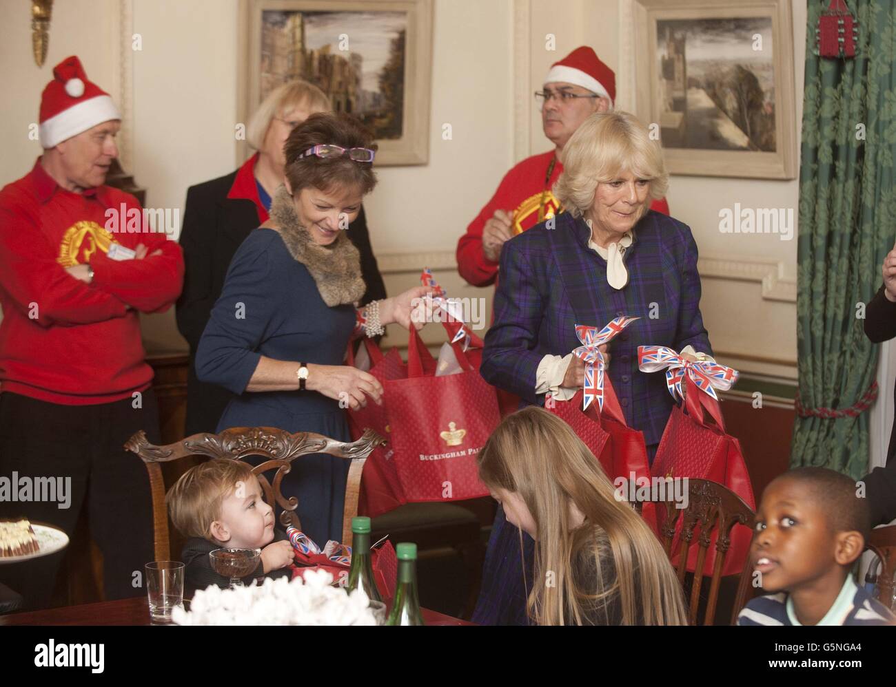 The Duchess of Cornwall meets her guests as she invited a group of youngsters to Clarence House, London, to help decorate her Christmas tree. PRESS ASSOCIATION Photo. Picture date: Wednesday December 12, 2012. Camilla got into the festive spirit and was ably assisted by children with life-shortening diseases. The eight youngsters, who receive support from the Helen & Douglas House Hospice, based in Oxford, not only placed baubles on the tree but also enjoyed a bangers-and-mash lunch with the Duchess. Camilla is patron of the hospice, which provides respite and end- of-life care for youngsters Stock Photo