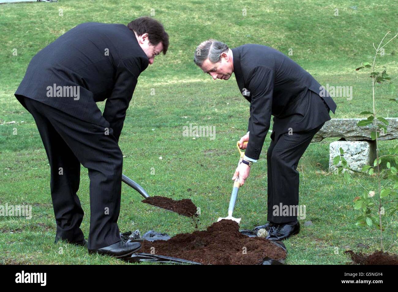 The Prince of Wales at The Glencree Reconciliation Centre in Co Wicklow, planting a tree with Brian Cowan, Republic of Ireland's Minister for Foreign Affairs (L), on the final day of his two day visit to the Republic. * The centre is a one-time British Army barracks that is now a headquarters for reconciliation. Stock Photo