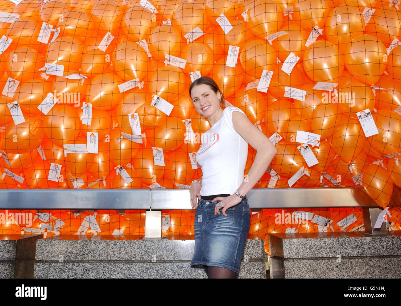 Model Kate Groombridge, launches 4,000 balloons for World Vision's fundraiser Orangeapeel at London Bridge in London. The 'Orangeapeel' is a national appeal which aims to raise funds for children affected by war. Stock Photo