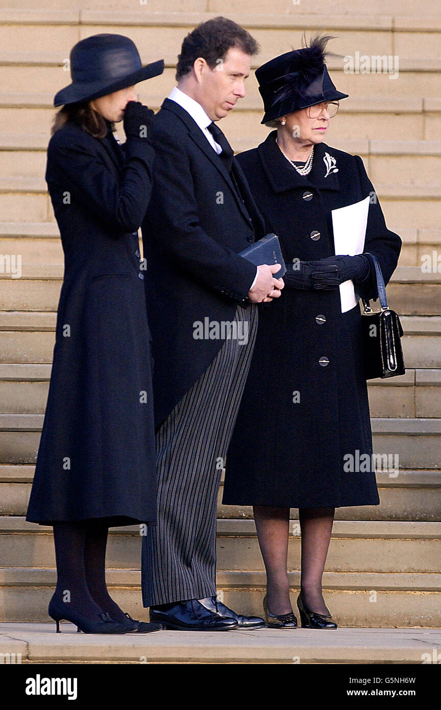 WARNING - NO CROPPING: Britain's Queen Elizabeth II (right) Viscount Linley (centre) and Sarah Chatto watch as the coffin of Princess Margaret leaves St George's Chapel in Windsor Castle. Princess Margaret died aged 71. * Note to editors (not for publication): Photographers have been asked not to take close-up pictures of Princess Margaret's children and young people attending today's funeral. Editors are therefore asked NOT to substantially recrop this image* Stock Photo