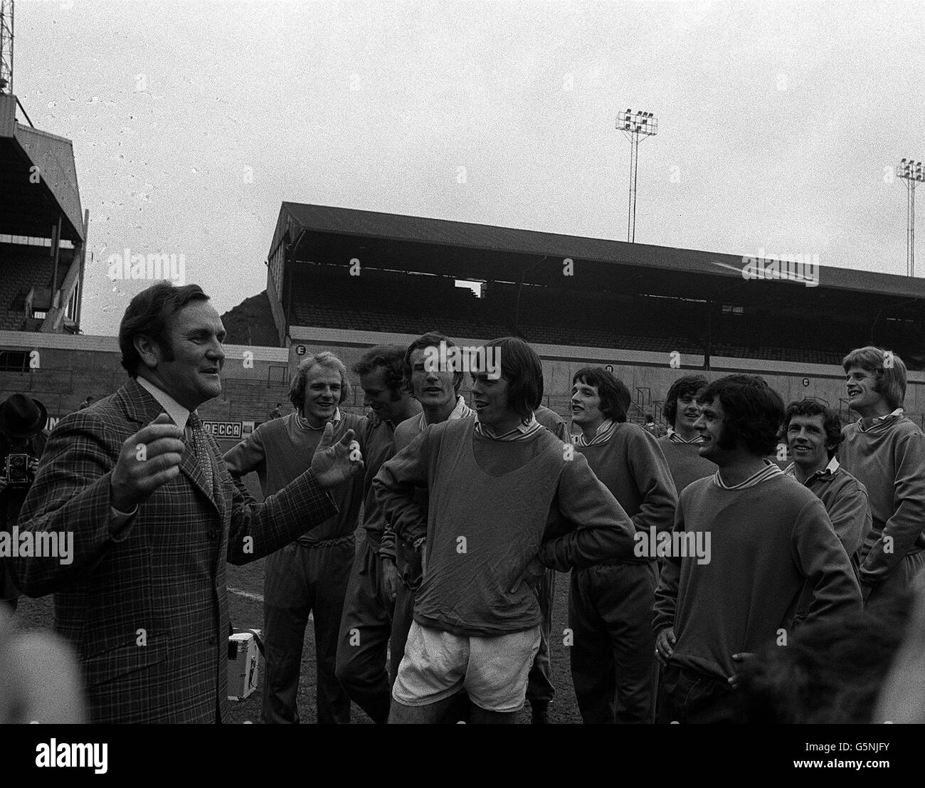 Leeds manager Don Revie leads his players in a rendition of 'Its a grand team to play for' at Elland Road, celebrating winning the league after Arsenal defeated Liverpool at Anfield. Stock Photo