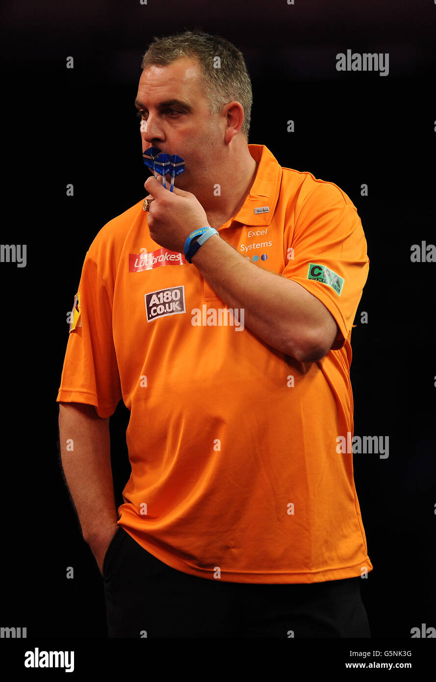 England's James Richardson looks ponderous during his First Round Match against England's Andy Hamilton during the Ladbrokes.com World Darts Championship at Alexandra Palace, London. Stock Photo