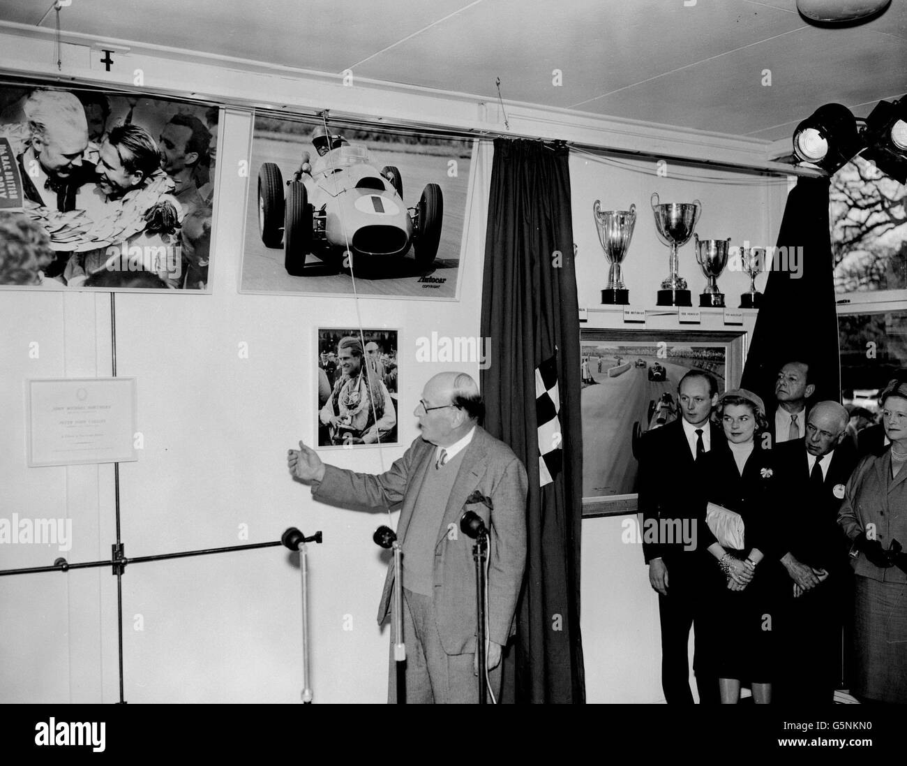 Lord Brabazon of Tara unveils a memorial to racing drivers Mike Hawthorn and Peter Collins at a new extension to the motor museum at Beaulieu Abbey, Hampshire opened today. Watching at right are Lord Montagu (extreme left) founder of the museum. Stock Photo
