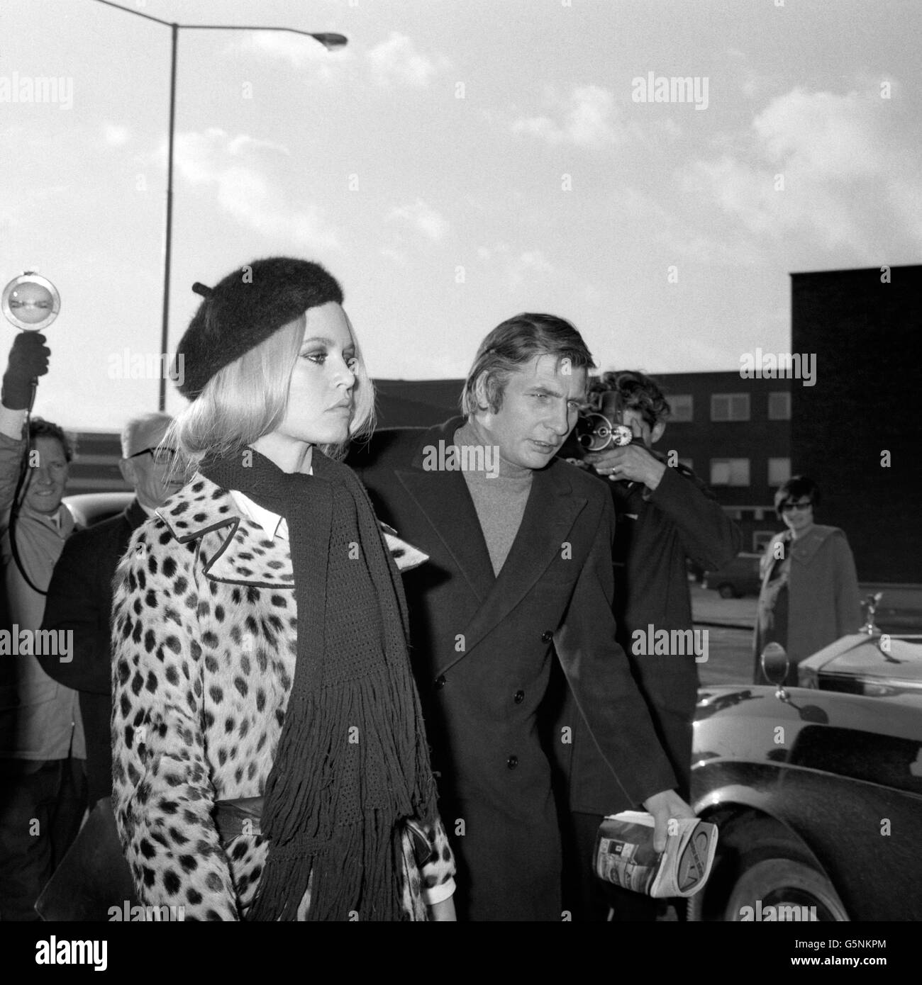 French film star, Brigitte Bardot, accompanied by her German millionaire husband, Gunther Sachs, is shown on arrival from Paris, at Heathrow Airport. Stock Photo