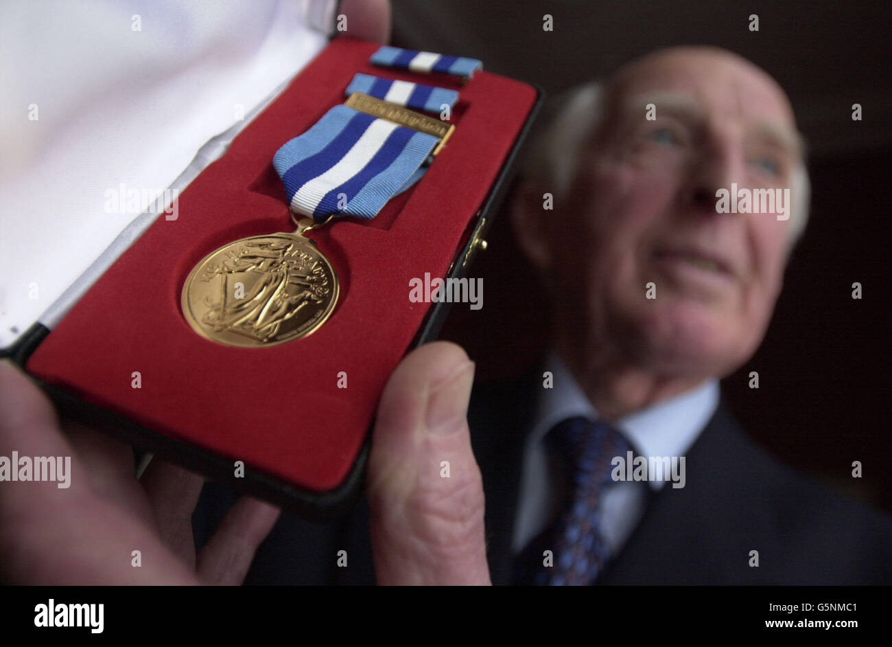 Merchant sailor Desmond Taylor, who served in the Second World War on the Irish Alder, with his Valour Award, presented to him at Dublin Castle, Ireland, by the Junior Marine Minister, Hugh Byrne, at a ceremony honouring the role of the Irish merchant fleet. * during World War II. Stock Photo