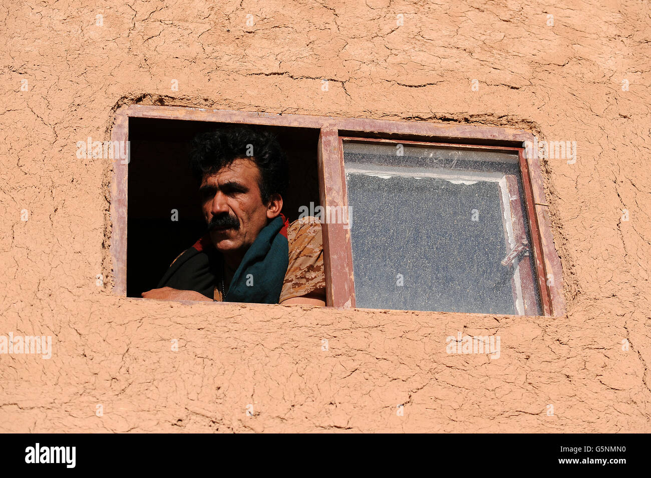 A member of the Afghan National Army (ANA) looks out from checkpoint Chara-He, Helmand Province, Afghanistan Stock Photo