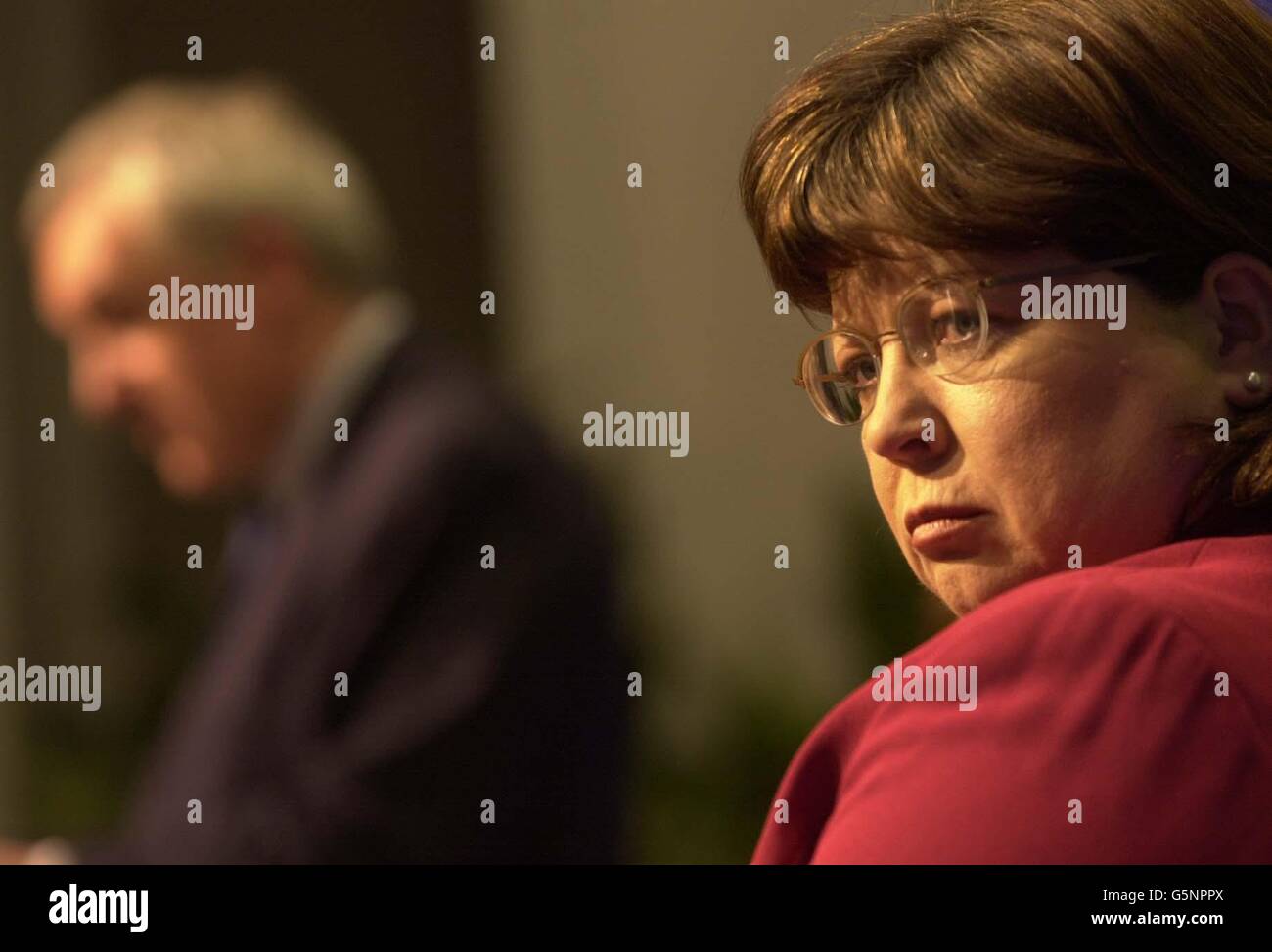 Deputy Prime Minister, Mary Harney listens to Irish Prime Minister Bertie Ahern speak at a press conference followinga split between the two on the building of a new stadium in Dublin, that threatens the chances of a joint Scottish/Irish bid to host the Euro 2008 soccer tournament. 22/04/2002 : Deputy Prime Minister, Mary Harney listening to Irish Prime Minister Bertie Ahern (background) at a press conference following their disagreement over the building of a new sports stadium in Dublin. Stock Photo