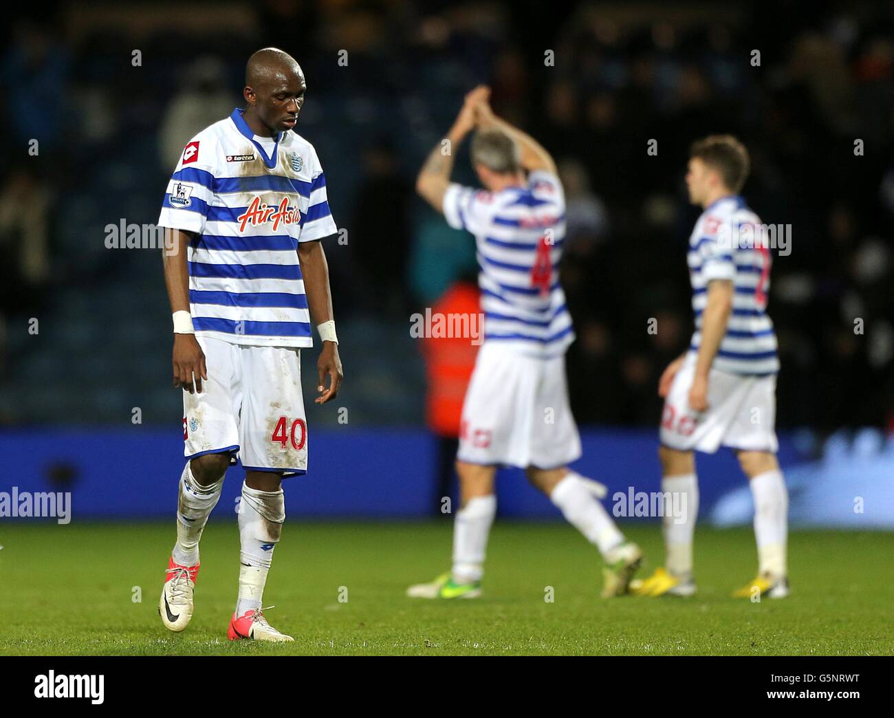 Soccer - Barclays Premier League - Queens Park Rangers v Liverpool - Loftus Road. Queens Park Rangers' Stephane Mbia stands dejected after the game Stock Photo