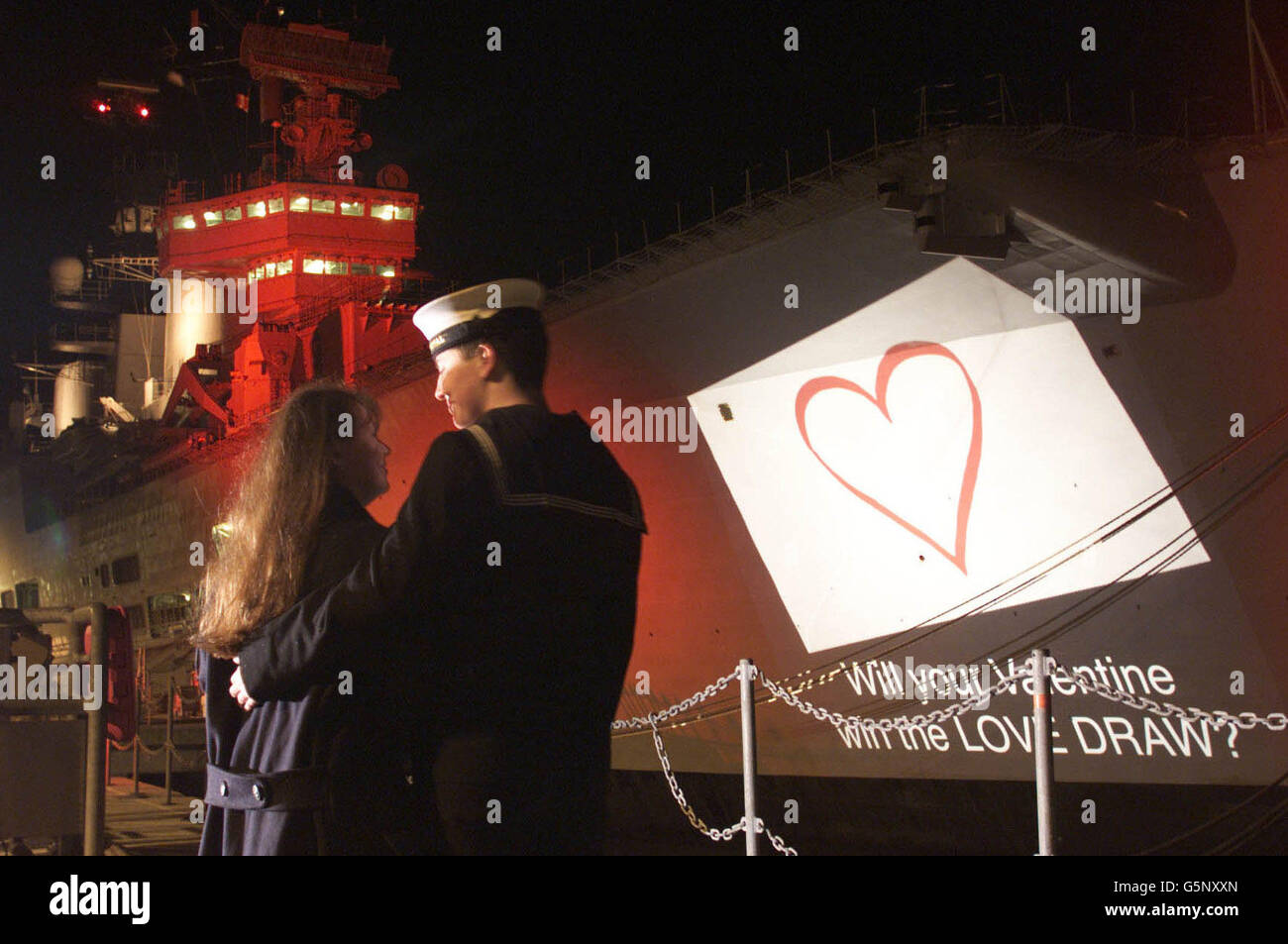 The Royal Mail launches its Valentine's Day Love Draw at the Naval Dockyard in Portsmouth with the aid of the Royal Navy aircraft carrier HMS Ark Royal. Customers who draw a heart on the back of a parcel or letter, are entered into the draw, * with the chance of winning a pair of Jaguar XK8 convertibles, as well as numerous other prizes such as a holiday in Barbados, bottles of champaign, restaurant vouchers and hot air balloon trips. The draw runs up until February 13 and is open to all UK residents over 16. PA Photo: Chris Ison. Stock Photo