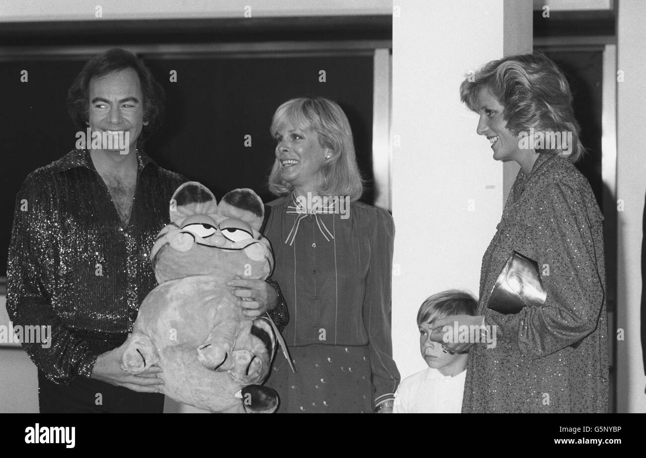 The Princess of Wales meets Neil Diamond at the National Exhibition Centre in Birmingham, where he gave a concert in aid of the Prince's Trust. Also in the picture are Diamond's wife Marsha and their son Micha. The singer is holding a Garfield toy, which he later presented to the princess, who is expecting her second child in September. *Low res scan - hi res version available on request* Stock Photo